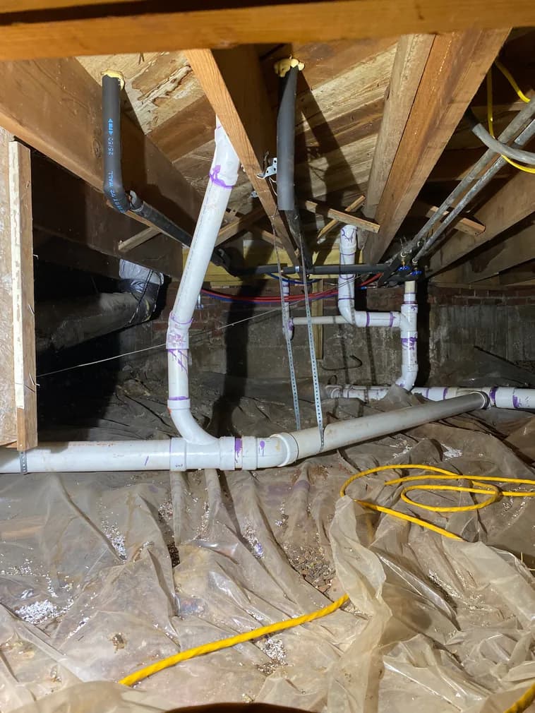 PVC drain pipe installation in crawl space