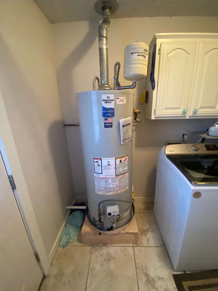 Bradford White water heater with expansion tank installed in a laundry room