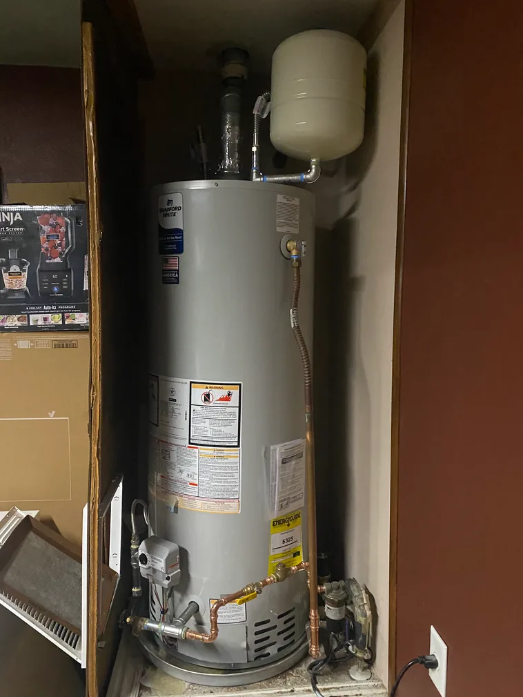 Bradford White tank water heater with expansion tank installed in a closet