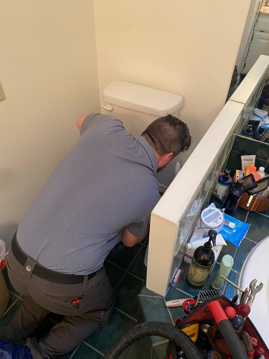All Calls Plumbing technician repairing a toilet